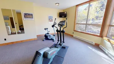 a gym with two exercise bikes and a mirror at Fully Renovated Penthouse Loft at Fernie Alpine Resort in Fernie