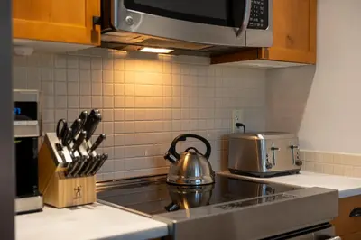 a tea kettle sitting on a stove in a kitchen at Fully Renovated Penthouse Loft at Fernie Alpine Resort in Fernie