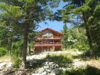 a house in the woods with trees at Pemberton Tree Lodge in Pemberton