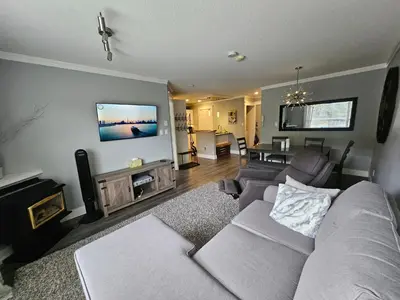 a living room with a couch and a tv at White-Tail Hollow - 309 - 1105 Henry Rd in Courtenay