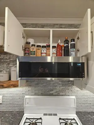 a microwave above a stove in a kitchen at White-Tail Hollow - 309 - 1105 Henry Rd in Courtenay