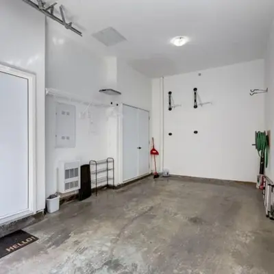 an empty room with white walls and a concrete floor at Stunning Modern 2BR Unit in Downtown Canmore in Canmore