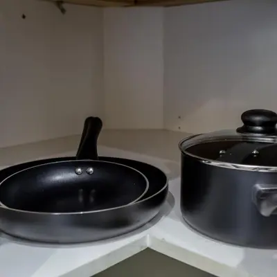a black pan sitting on top of a stove at BoHo House-Sleeps 17-Garage-3 Kitchens-Fireplace in Edmonton