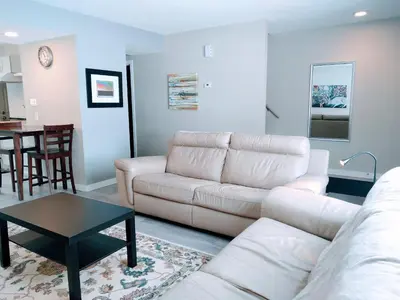 a living room with a couch and a table at UofA Bike Lane-Train-Bus- Southgate Mall, Cental in Edmonton