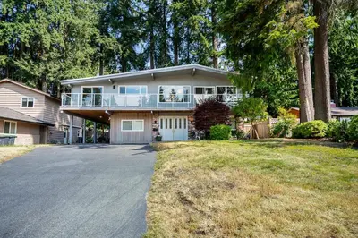 a large house with a balcony and a driveway at Serene Nature Retreat in North Vancouver