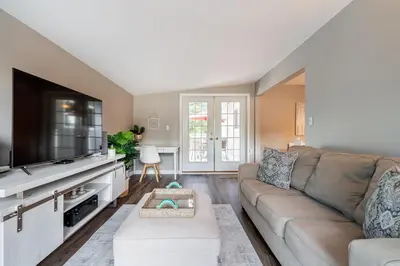 a living room with a couch and a flat screen tv at Serene Nature Retreat in North Vancouver