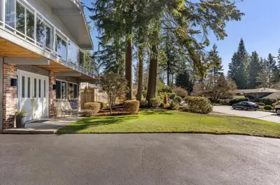 a house with a driveway in front of it at Serene Nature Retreat in North Vancouver