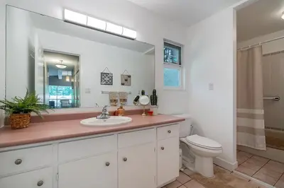 a bathroom with a sink and a toilet and a mirror at Serene Nature Retreat in North Vancouver