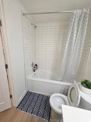 a bathroom with a tub and a toilet at Amaville - One BRM Private Suite in West Edmonton in Edmonton