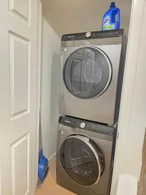 a dryer and a washing machine in a room at Amaville - One BRM Private Suite in West Edmonton in Edmonton