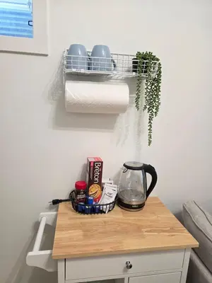 a kitchen counter with a coffee pot and paper towels at Amaville - One BRM Private Suite in West Edmonton in Edmonton