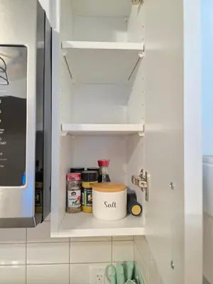 a kitchen pantry with a white cabinet with spices at Amaville - One BRM Private Suite in West Edmonton in Edmonton