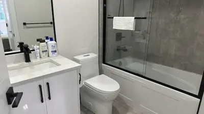 a bathroom with a shower and a toilet and a sink at Metrotown area in Vancouver