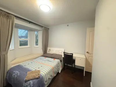 a bedroom with a bed and a desk and a window at W 20 House in Vancouver