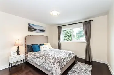 a bedroom with a bed and a window at W 20 House in Vancouver