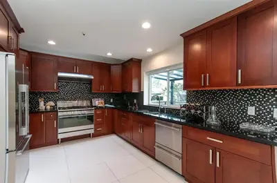 a large kitchen with wooden cabinets and appliances at W 20 House in Vancouver