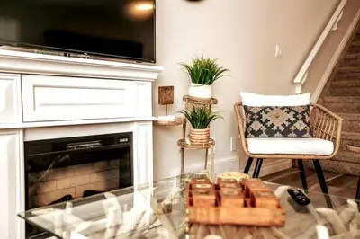 a living room with a fireplace and a glass table at Luxe Escape Duo - 8 Beds - Sleeps 22 - 4 Car Garage in Edmonton