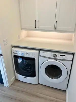 a white washer and dryer in a kitchen at Camelia Home in Kelowna