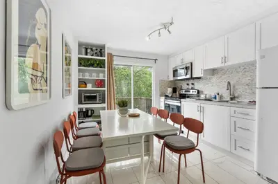 a kitchen with a white table and chairs at Heritage Home in Heart of City with free Parking in Vancouver