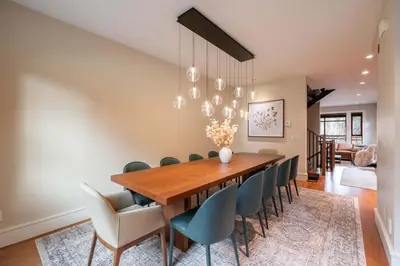 a dining room with a wooden table and chairs at Fitzsimmons Walk 15 by Outpost Whistler in Whistler