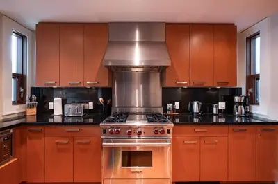 a kitchen with wooden cabinets and a stove top oven at Fitzsimmons Walk 15 by Outpost Whistler in Whistler