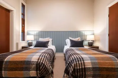 two beds in a hotel room with two lamps at Fitzsimmons Walk 15 by Outpost Whistler in Whistler