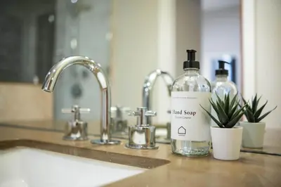 a bottle of liquid soap sitting next to a sink at Fitzsimmons Walk 15 by Outpost Whistler in Whistler