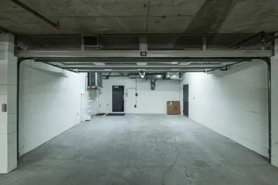 an empty garage with white walls and concrete floors at Fitzsimmons Walk 15 by Outpost Whistler in Whistler