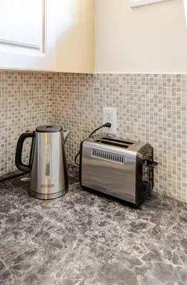 a toaster sitting on top of a kitchen counter at Spacious & Cozy 1 Bedroom Suite in North Vancouver in North Vancouver