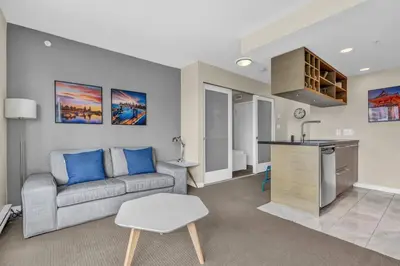 a living room with a couch and a kitchen at Corporate Stays Capitol Residences 1 Bedroom in Vancouver