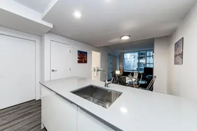 a kitchen with a sink in a white counter top at Corporate Stays Tate 1 Bedroom in Vancouver