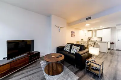 a living room with a couch and a tv and a table at Corporate Stays Tate 1 Bedroom in Vancouver