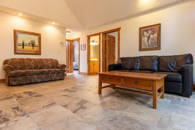 a living room with a couch and a coffee table at Black Diamond Chalet by Fernie Central Reservations in Fernie