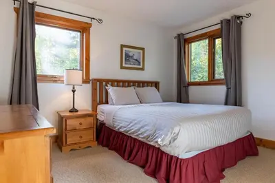 a bedroom with a bed and a window at Black Diamond Chalet by Fernie Central Reservations in Fernie