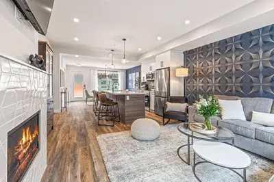 a living room with a couch and a fireplace at Classic Modern 4BR Nearby DT Hot tub and Pool in Canmore