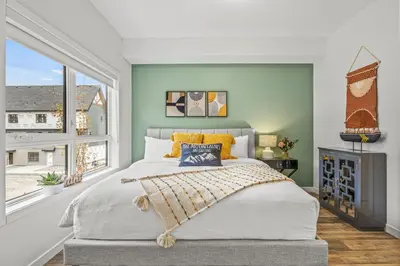a bedroom with a large bed and a large window at Mountain Modern 2BR Townhome with Stunning View in Canmore