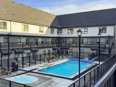 a view of a swimming pool in front of a building at Mountain Modern 2BR Townhome with Stunning View in Canmore