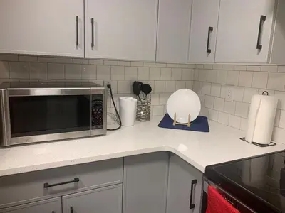 a kitchen counter with a microwave and a mixer at Modern and cozy stay-2 Bedroom Basement in Edmonton