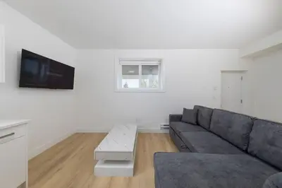 a living room with a couch and a tv at Tranquil 2-Bedroom Basement Suite Relaxing Stay in Chilliwack