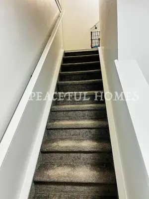 a flight of stairs in a building at Peaceful Homes - Elegant 2 Bedroom Suite in Calgary