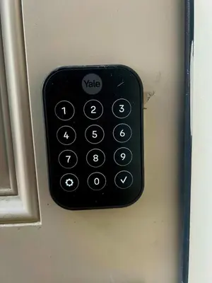 a black remote control on the side of a door at Peaceful Homes - Elegant 2 Bedroom Suite in Calgary