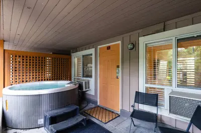a house with a hot tub on a porch at Private Hot Tub | Free Parking | Pool | Sauna in Whistler