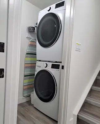 a washing machine and a dryer in a room at L&D Luxury Suite in Nisku