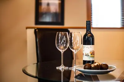 a bottle of wine and two wine glasses on a table at Timberloft by Revelstoke Vacations in Revelstoke