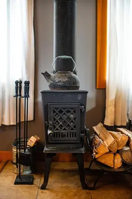 an old black stove sitting in a room at Timberloft by Revelstoke Vacations in Revelstoke