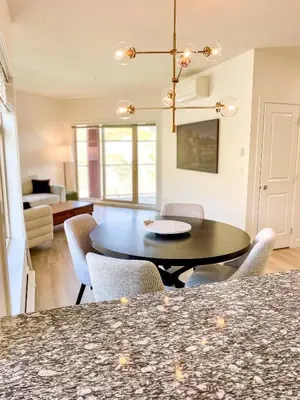a dining room and living room with a table and chairs at Lakeview Retreat in West Kelowna in West Kelowna