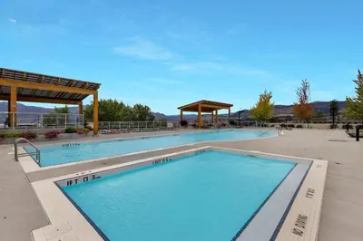 a large swimming pool with a gazebo at Lakeview Retreat in West Kelowna in West Kelowna