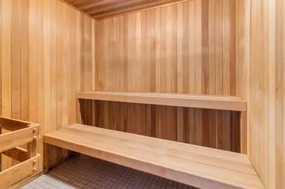 a sauna with wooden walls and wooden shelves at Lakeview Retreat in West Kelowna in West Kelowna