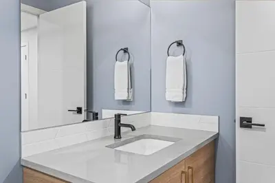 a bathroom with a sink and a mirror at Spacious 3BR Haven in Scenic Canmore in Canmore