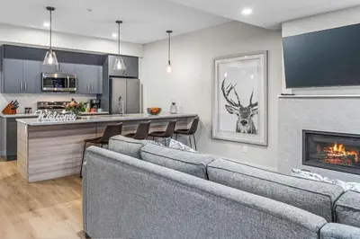 a living room with two couches and a fireplace at Spacious 3BR Haven in Scenic Canmore in Canmore